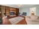 Cozy living room with brick fireplace and wood floors, furnished with chairs and a sofa at 11424 Horsemans Trl, Raleigh, NC 27613