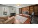 Living room featuring a brick fireplace, dark wood floors, and bright natural light at 11424 Horsemans Trl, Raleigh, NC 27613