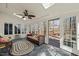 Sunroom with skylights, ceiling fan, and comfortable seating, and access to an outdoor deck at 11424 Horsemans Trl, Raleigh, NC 27613