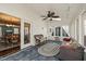Bright sunroom with skylights, ceiling fan, and comfortable seating, connected to dining room at 11424 Horsemans Trl, Raleigh, NC 27613