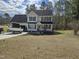 Charming two-story home with black shutters, attached garage, and boat parked in the driveway at 1201 Teakwood Ct, Sanford, NC 27330