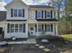 Close-up of a charming two-story home showcasing the welcoming front porch at 1201 Teakwood Ct, Sanford, NC 27330