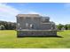 Stunning backyard with large stone retaining wall and manicured lawn at 124 Brookstone Way, Angier, NC 27501