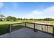 Wooden deck overlooking a backyard with lush green grass at 124 Brookstone Way, Angier, NC 27501