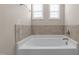 Close up on tiled tub with silver fixtures at 124 Brookstone Way, Angier, NC 27501