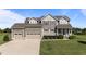 Attractive two-story home featuring a three-car garage and a well-kept front yard at 124 Brookstone Way, Angier, NC 27501