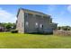 Exterior view of a spacious home, featuring a large backyard and patio with a stone firepit at 124 Brookstone Way, Angier, NC 27501