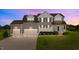 Twilight view of a lovely home with a three-car garage at 124 Brookstone Way, Angier, NC 27501