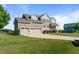 Eye-level view of a home with a well-kept lawn and a three-car garage at 124 Brookstone Way, Angier, NC 27501