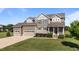 Charming two-story home with a manicured lawn and a three-car garage on a sunny day at 124 Brookstone Way, Angier, NC 27501