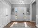 Bright foyer with hardwood floors, a decorative rug, and a white front door at 124 Brookstone Way, Angier, NC 27501