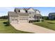 Well-kept property showcasing beautiful landscaping and a three-car garage at 124 Brookstone Way, Angier, NC 27501