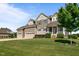 Charming two-story home with inviting front porch and three-car garage at 124 Brookstone Way, Angier, NC 27501