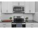 Contemporary kitchen design featuring modern appliances, granite counters, and white cabinets at 124 Brookstone Way, Angier, NC 27501