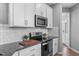 Contemporary kitchen design featuring modern appliances, granite counters, and white cabinets at 124 Brookstone Way, Angier, NC 27501