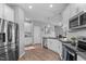 Modern kitchen with stainless steel appliances, granite counters, and white cabinets at 124 Brookstone Way, Angier, NC 27501