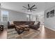 Cozy living room with a rustic wood coffee table, large sofa, and natural light at 124 Brookstone Way, Angier, NC 27501