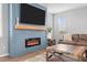 Comfortable living room with electric fireplace and wall-mounted TV above mantel at 124 Brookstone Way, Angier, NC 27501