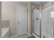 Glass enclosed tiled shower and soaking tub in the primary bathroom at 124 Brookstone Way, Angier, NC 27501