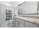 Well-lit bathroom featuring granite counters, a framed mirror, a sink, and a toilet with a privacy curtain at 124 Ferrell W Rd, Apex, NC 27523