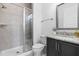 Cozy bathroom with gray cabinet, granite countertops, framed mirror, and glass enclosed shower at 124 Ferrell W Rd, Apex, NC 27523