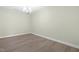 Minimalist bedroom featuring hardwood floors and modern light fixture, creating a serene atmosphere at 124 Ferrell W Rd, Apex, NC 27523