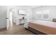 Clean and organized bedroom with light hardwood floors, a TV, and natural lighting at 124 Ferrell W Rd, Apex, NC 27523