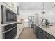 Modern kitchen features granite countertops, stainless steel appliances, and a stylish kitchen island at 124 Ferrell W Rd, Apex, NC 27523