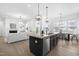 Spacious open-concept kitchen featuring a large island, modern appliances, and a dining area with ample natural light at 124 Ferrell W Rd, Apex, NC 27523