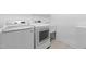 Practical laundry room featuring modern machines, sink, and neutral color palette at 124 Ferrell W Rd, Apex, NC 27523