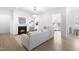 Comfortable living room with a fireplace, hardwood floors, modern furniture, and elegant chandelier at 124 Ferrell W Rd, Apex, NC 27523