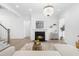 Bright living room featuring a fireplace, a decorative chandelier, and an open-concept design at 124 Ferrell W Rd, Apex, NC 27523