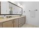 Elegant main bathroom with double vanity, neutral color palette, granite countertops, and a large mirror at 124 Ferrell W Rd, Apex, NC 27523