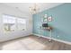 Stylish home office with bright windows, modern light fixture, and sleek adjustable standing desk at 124 Ferrell W Rd, Apex, NC 27523