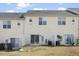 View of the back of home with a sliding glass door, trash cans and satellite dish at 1306 Plexor Ln, Knightdale, NC 27545