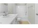 Bathroom featuring white cabinets and a shower and tub combo at 1306 Plexor Ln, Knightdale, NC 27545