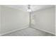 Bright bedroom features a ceiling fan, neutral walls, and plush gray carpeting at 1306 Plexor Ln, Knightdale, NC 27545