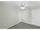Bedroom featuring gray carpet, neutral walls, a ceiling fan, and two white doors at 1306 Plexor Ln, Knightdale, NC 27545
