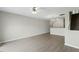 Open-concept living room featuring hardwood floors, ceiling fan and elegant lighting at 1306 Plexor Ln, Knightdale, NC 27545