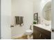 Bathroom featuring a vanity, toilet, decorative mirror and artwork at 14 Winchester Ct, Durham, NC 27707