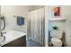 A clean bathroom featuring a shower with a curtain, toilet and sink with a vanity at 14 Winchester Ct, Durham, NC 27707