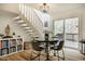 Cozy dining area with access to deck, featuring bright natural light and a charming staircase at 14 Winchester Ct, Durham, NC 27707