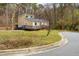 Two-story home featuring a wood deck, dormer, landscaped front yard, and street access at 14 Winchester Ct, Durham, NC 27707
