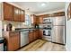 Functional kitchen featuring stainless steel appliances, wood cabinets, and durable countertops at 14 Winchester Ct, Durham, NC 27707