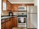Updated kitchen with stainless steel appliances, wooden cabinets and efficient layout for cooking at 14 Winchester Ct, Durham, NC 27707
