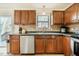 Well-lit kitchen with dark wood cabinets, modern stainless steel appliances, and durable countertops at 14 Winchester Ct, Durham, NC 27707