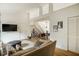 Bright, open living room with a staircase leading to a loft and a view into the dining room at 14 Winchester Ct, Durham, NC 27707