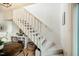 Bright staircase adjacent to a dining area, complete with a stylish bookshelf and white railing at 14 Winchester Ct, Durham, NC 27707