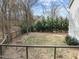 Backyard view from the deck showcasing its size, perimeter fence, and tree line at 1404 Vanguard Pl, Durham, NC 27713