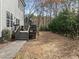 View of the home's backyard with wooden deck, well-manicured lawn, and mature landscaping at 1404 Vanguard Pl, Durham, NC 27713